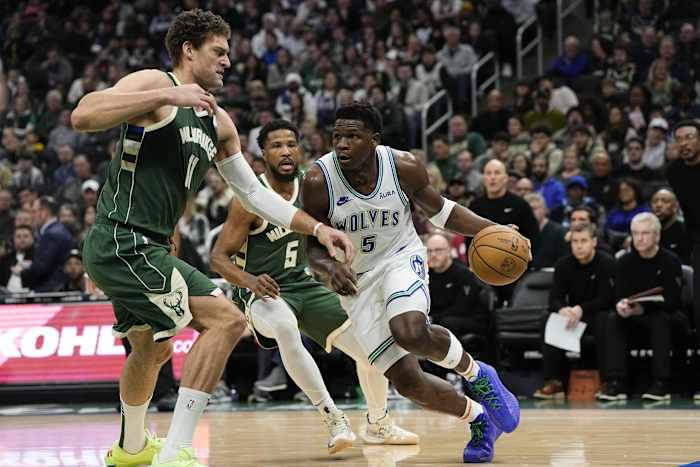 Minnesota Timberwolves guard Anthony Edwards (5) drives for the basket against Milwaukee Bucks center Brook Lopez (11)